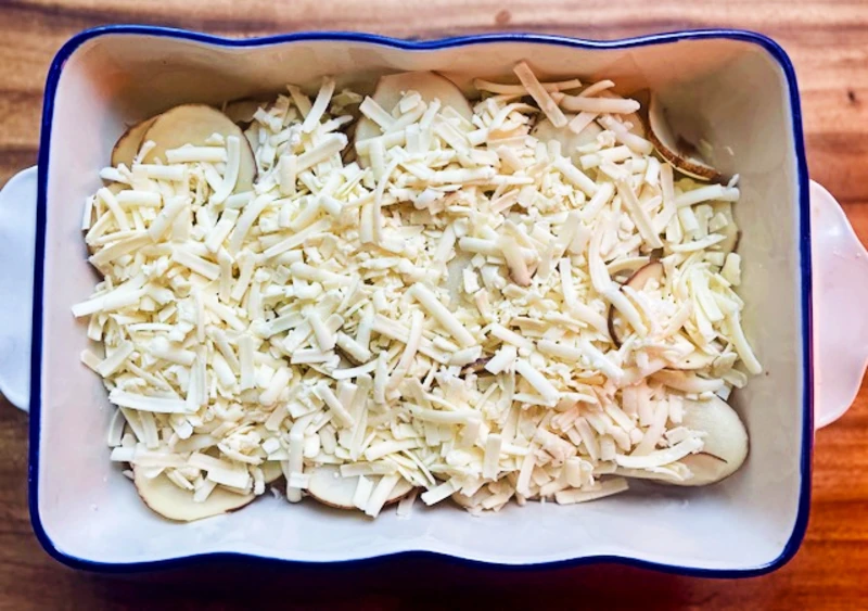 layers of thinly sliced potatoes and cheese for au gratin potatoes