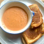 Easy Creamy Roasted Tomato Soup made with fresh garden tomatoes, onion, and garlic. A cozy, comforting soup perfect for summer harvest or chilly fall nights. Pin this recipe for delicious homemade soup to warm up with!