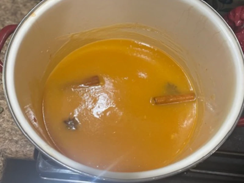 smooth peach butter simmering with spices