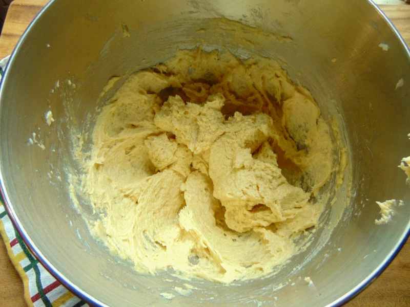 eggs and vanilla mixed into dough for pecan chocolate chip cookies