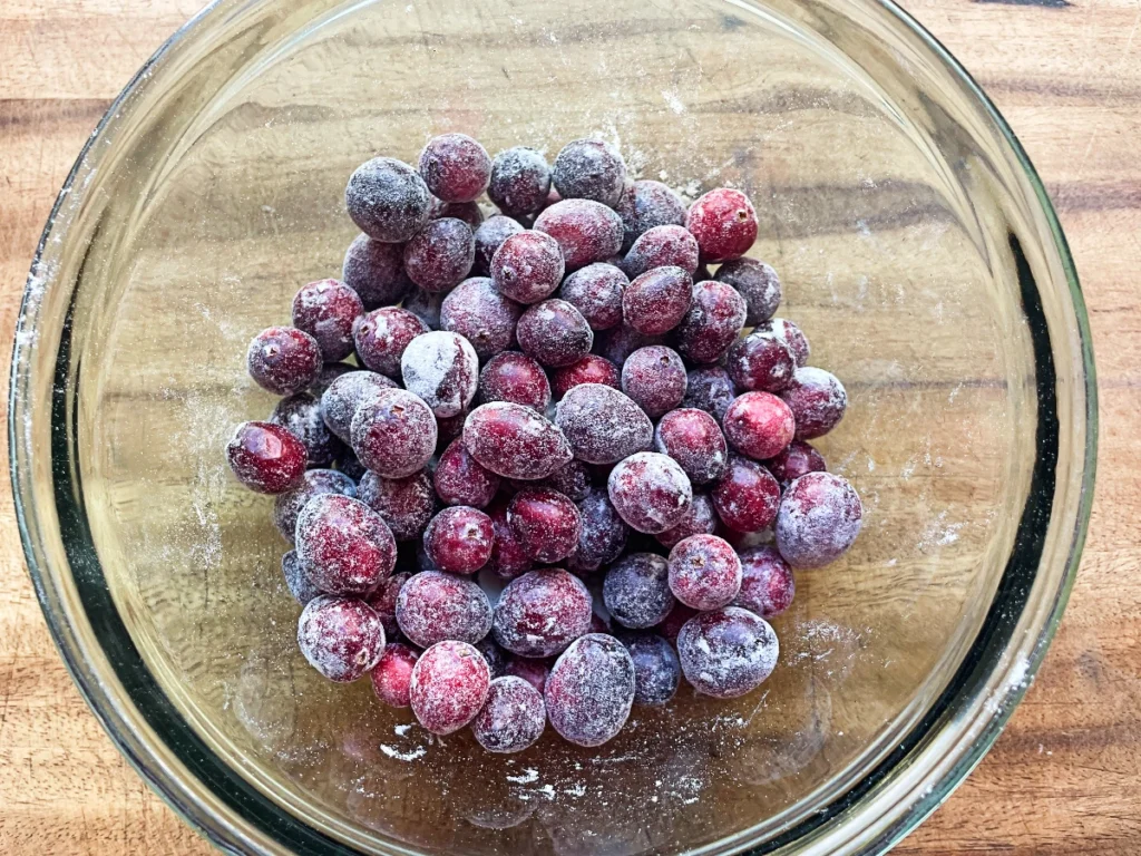 cranberries lightly floured in a bowl for cranberry orange quick bread