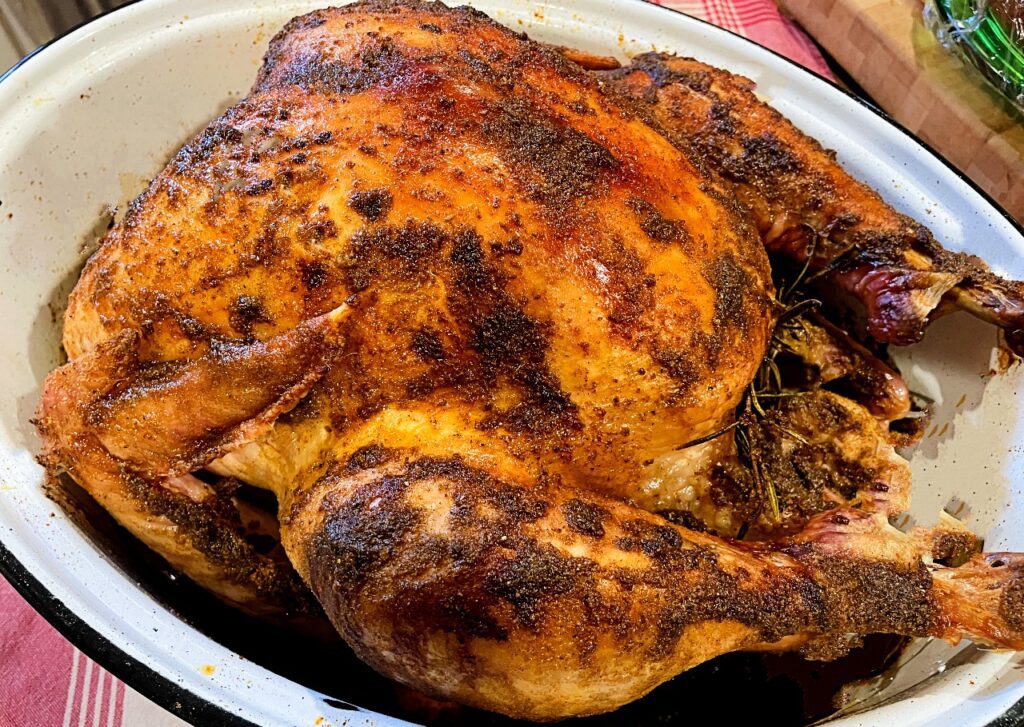 Golden brown roasted turkey in roasting pan
