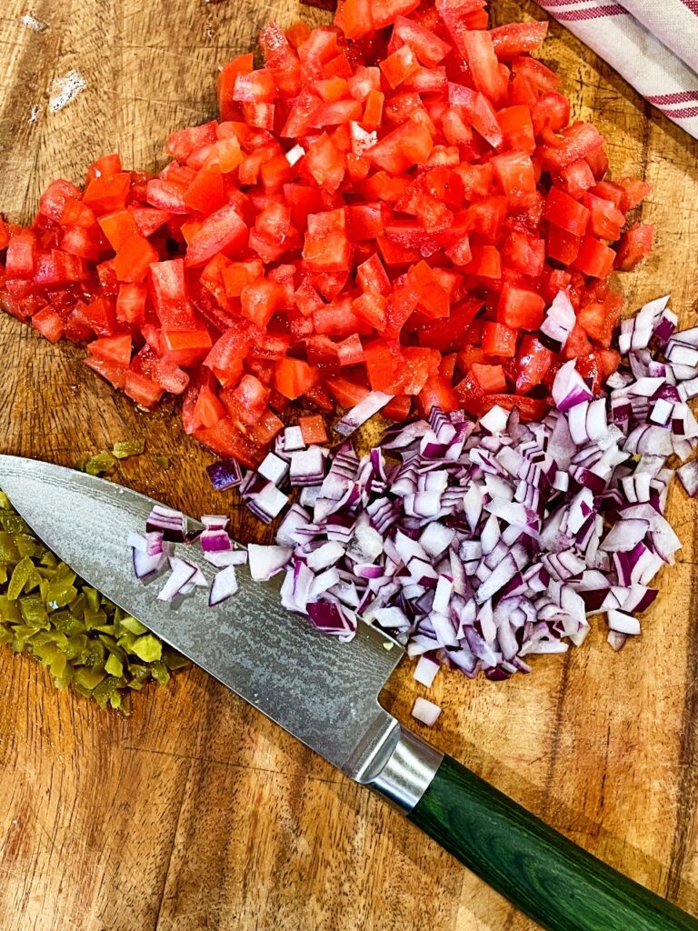 ingredients chopped on a cutting board for pico de gallo