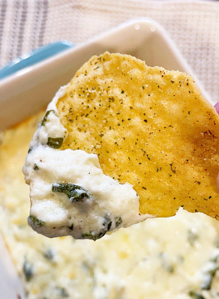 white cheddar spinach dip on a chip