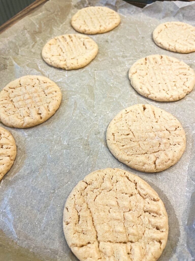 Baked peanut butter cookies on parchment