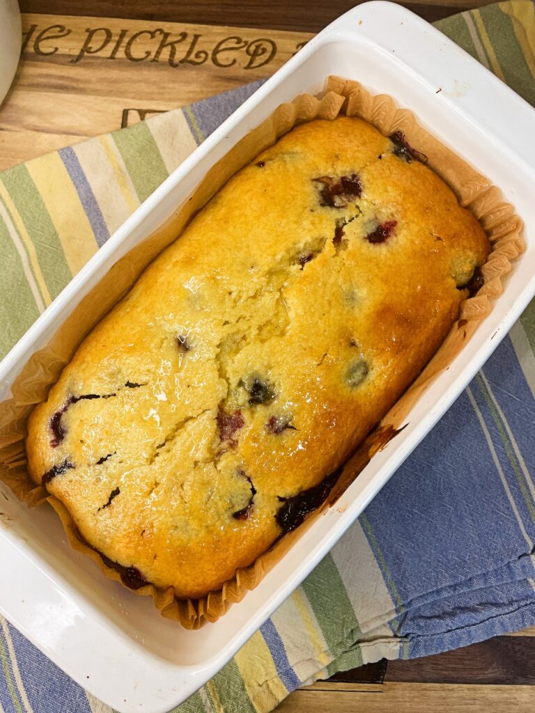 lemon syrup brushed over warm lemon blueberry loaf
